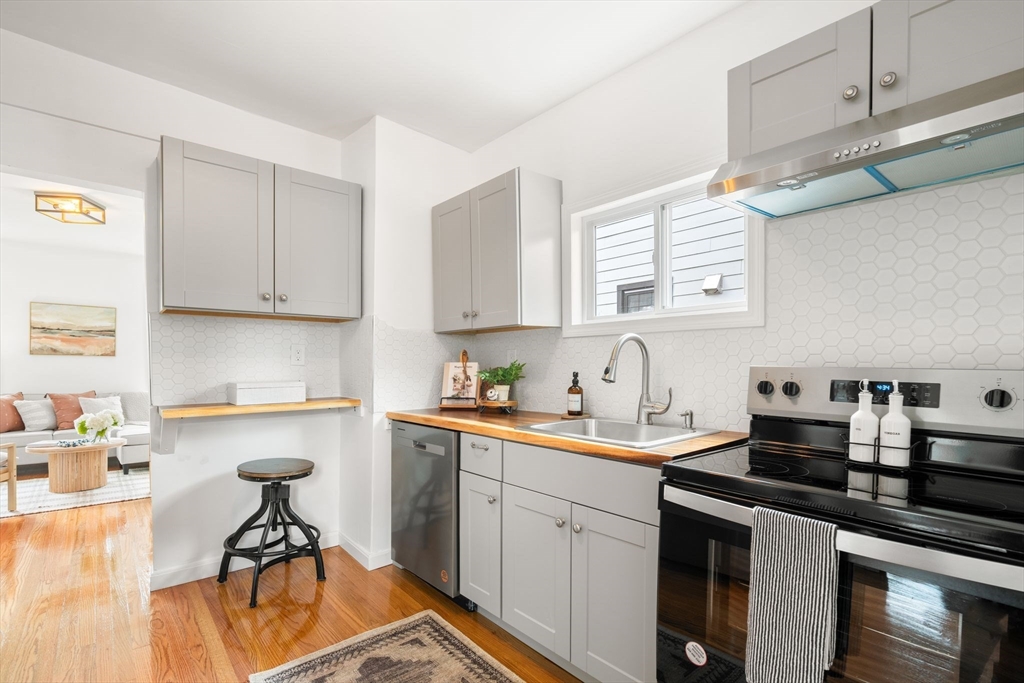 19 Berkley Road Hull, MA 02045 - Photo 17 of 42 a kitchen with stainless steel appliances a sink a stove and cabinets