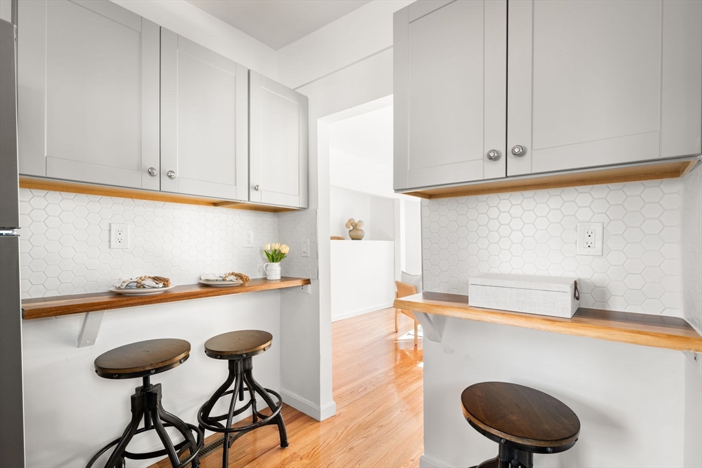 19 Berkley Road Hull, MA 02045 - Photo 19 of 42 a kitchen with a sink a stove and white cabinets