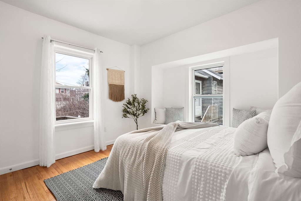 19 Berkley Road Hull, MA 02045 - Photo 23 of 42 a bedroom with a bed windows and wooden floor