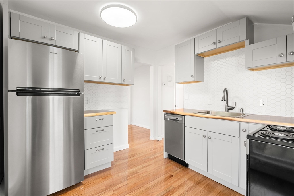 19 Berkley Road Hull, MA 02045 - Photo 29 of 42 a kitchen with white cabinets and white appliances