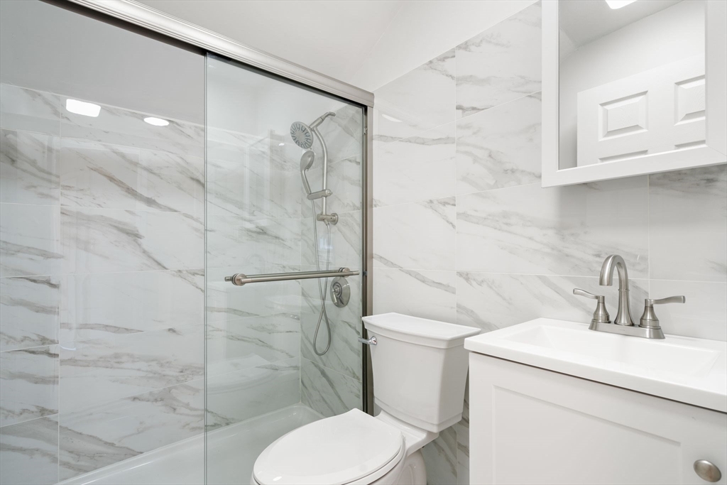 19 Berkley Road Hull, MA 02045 - Photo 39 of 42 a bathroom with a toilet sink and shower