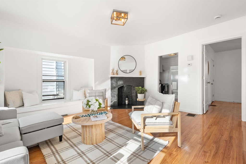 19 Berkley Road Hull, MA 02045 - Photo 10 of 42 a living room with furniture a fireplace and a table