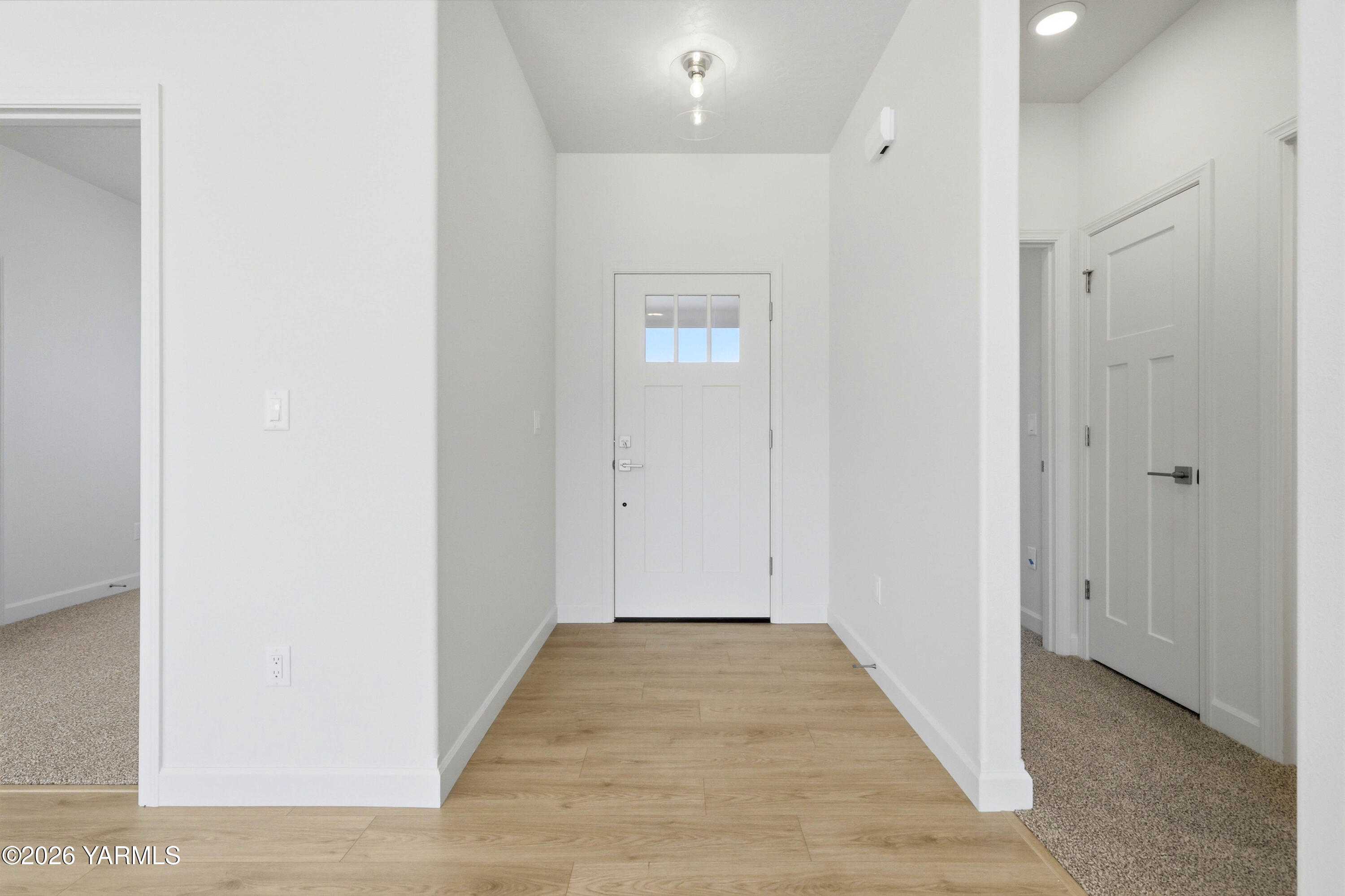 218 Packer Street Prosser, WA 99350 - Photo 4 of 36 a view of a hallway with wooden floor