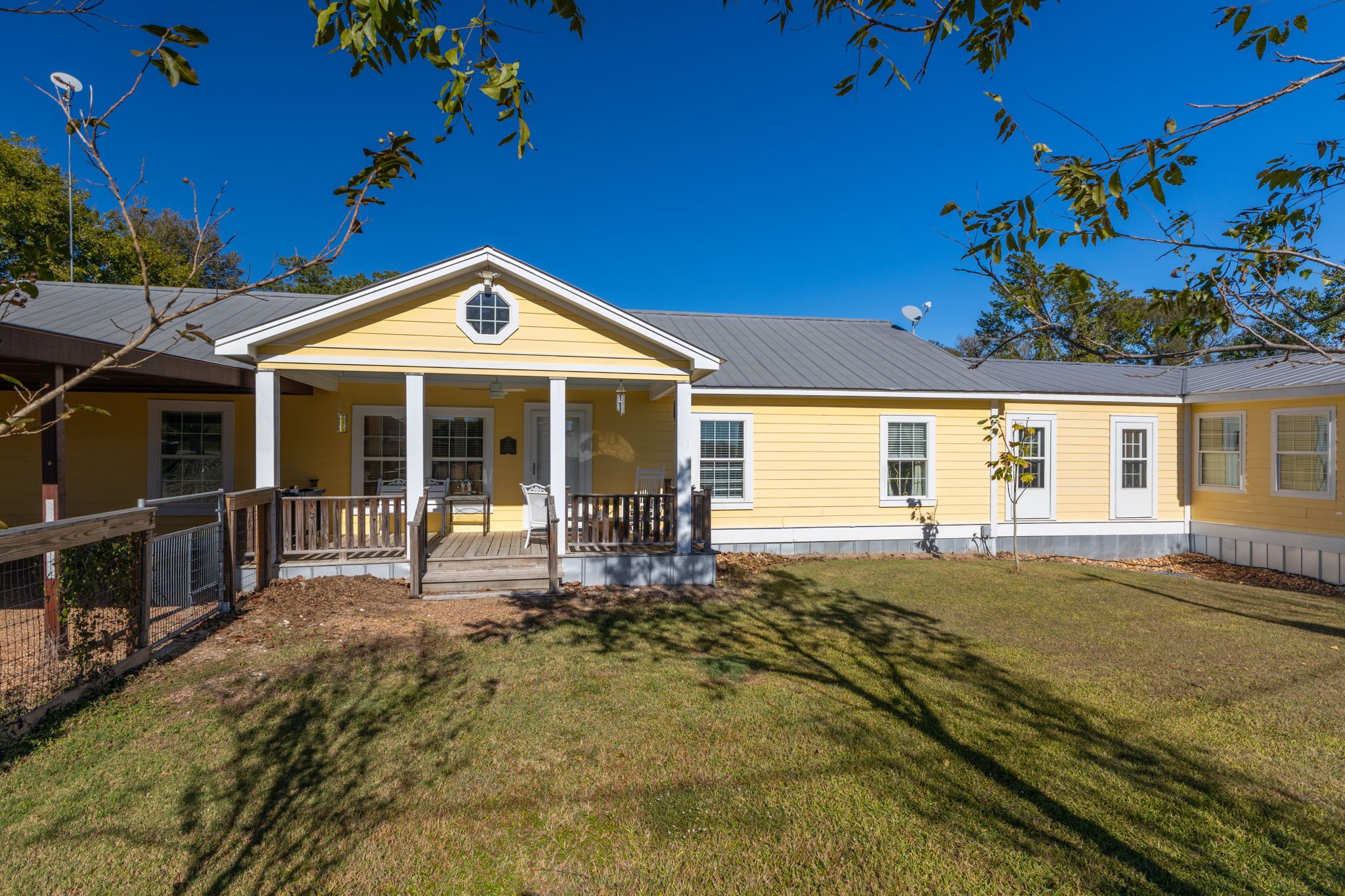 8103 Adamek Road Brenham, TX 77833 - Photo 2 of 42 a front view of a house with a garden
