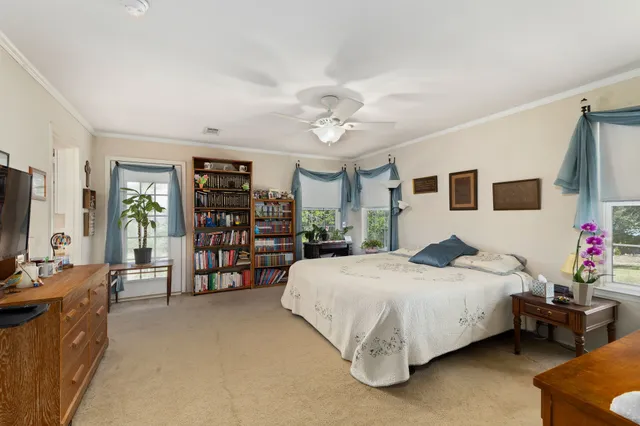 a living room with furniture kitchen view and a chandelier