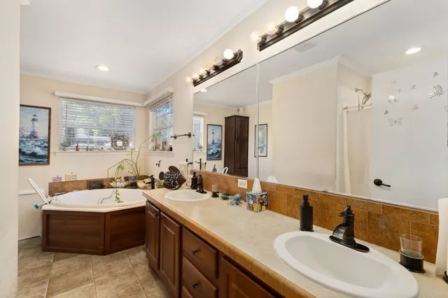 a bedroom with a bed a flat screen tv and dresser