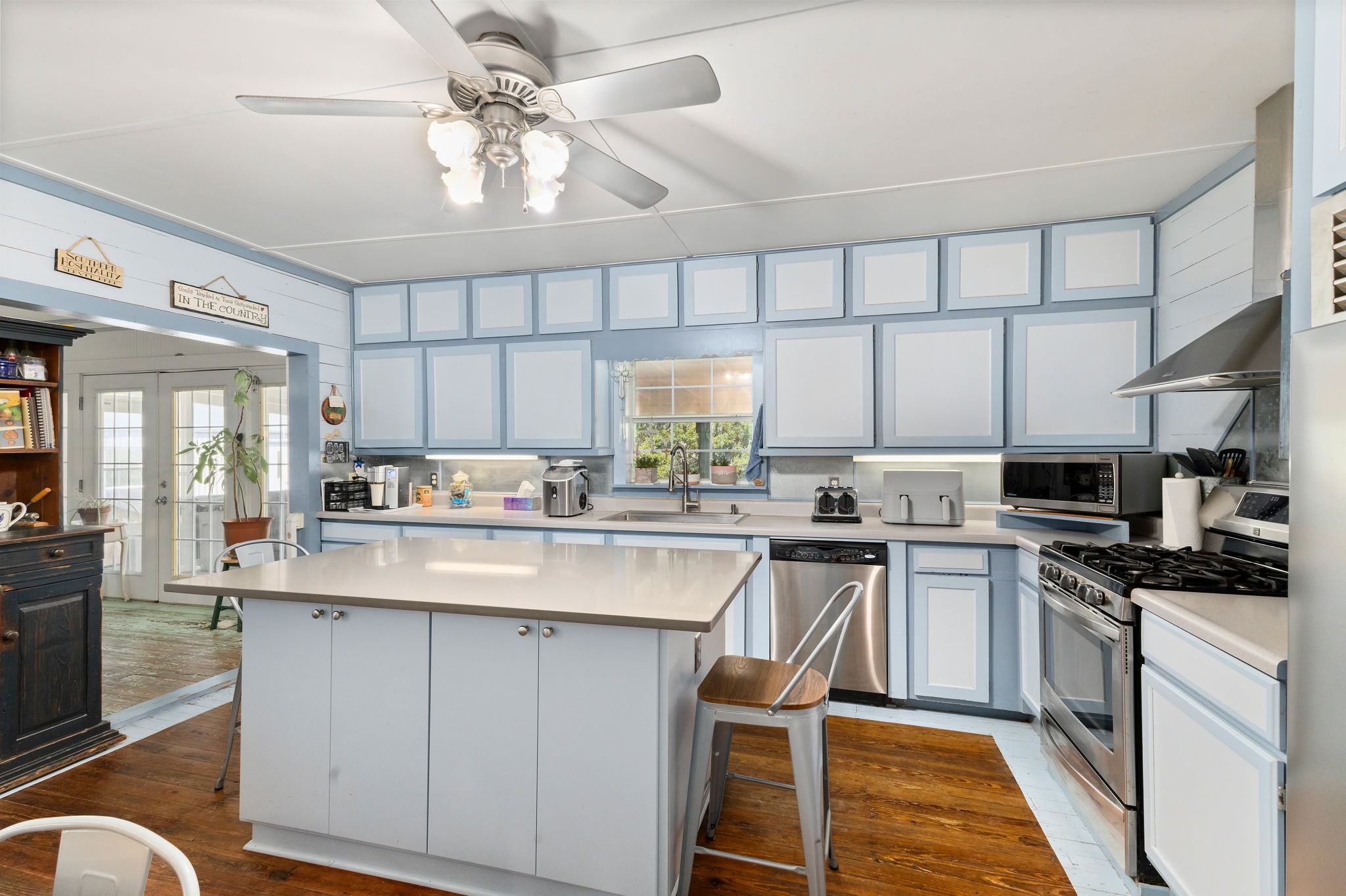 8103 Adamek Road Brenham, TX 77833 - Photo 6 of 42 a kitchen with appliances a sink and cabinets