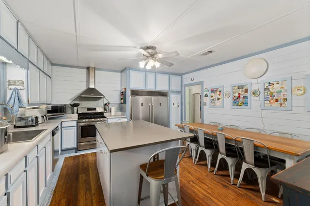 a kitchen with appliances a sink and cabinets