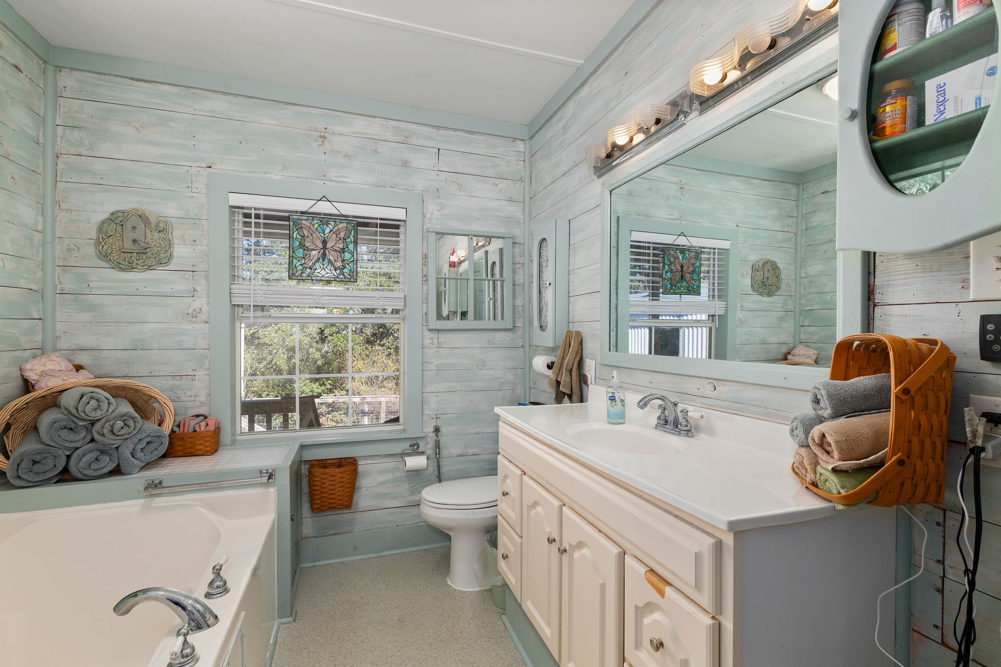 8103 Adamek Road Brenham, TX 77833 - Photo 9 of 42 a bathroom with a tub sink and mirror