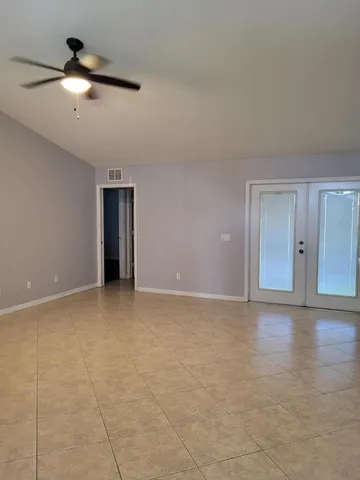 a view of an empty room with a ceiling fan