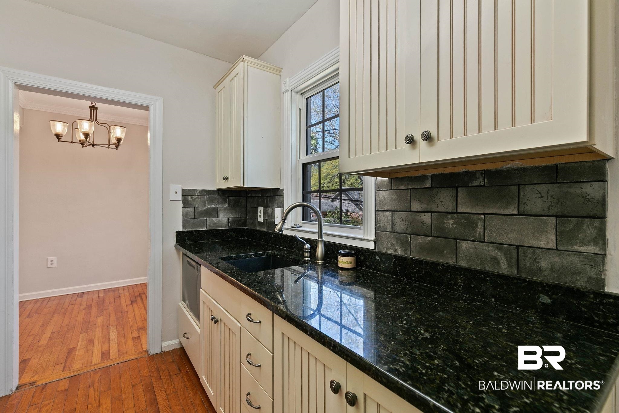 214 Upham Street, Unit 8D Mobile, AL 36607 - Photo 14 of 36 Kitchen with tasteful backsplash, dark wood-style floors, dark stone countertops, suspended lighting, and dishwasher