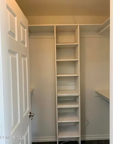 a view of walk in closet with empty racks