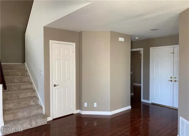 wooden floor in an empty room with a gallery