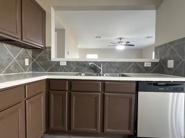 a kitchen with a sink and cabinets