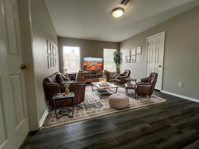 a living room with furniture a window and piano table