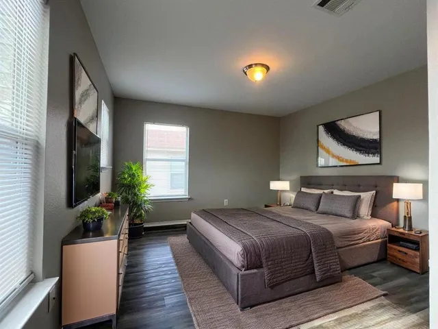 a bedroom with bed and a potted plant