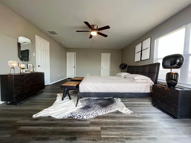 a bedroom with a bed and wooden floor