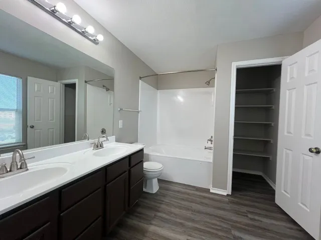 a bathroom with a double vanity sink and a mirror