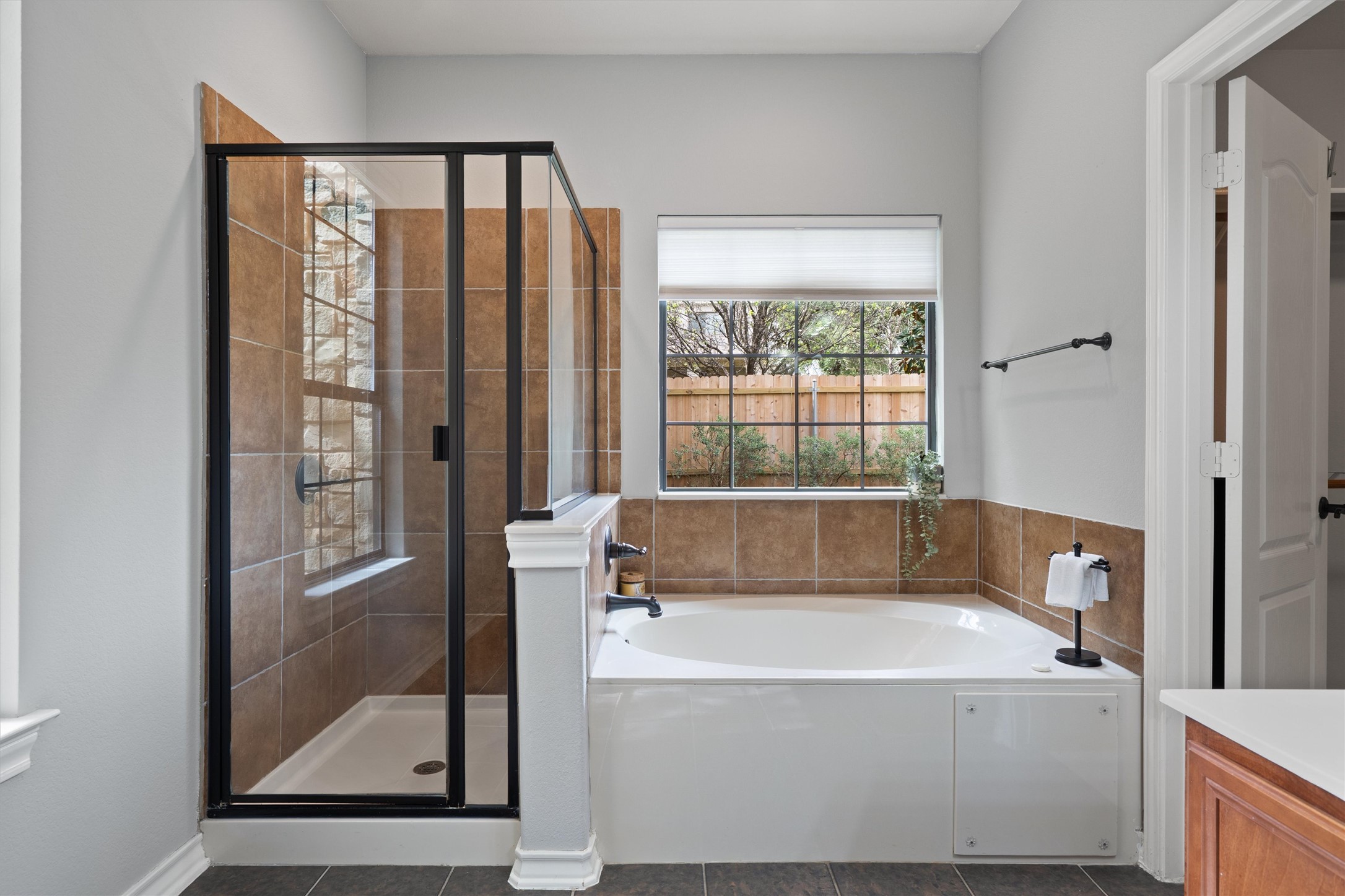 101 Breakaway Road Cedar Park, TX 78613 - Photo 20 of 37 Bathroom featuring a shower stall, vanity, a bath, and dark tile patterned flooring