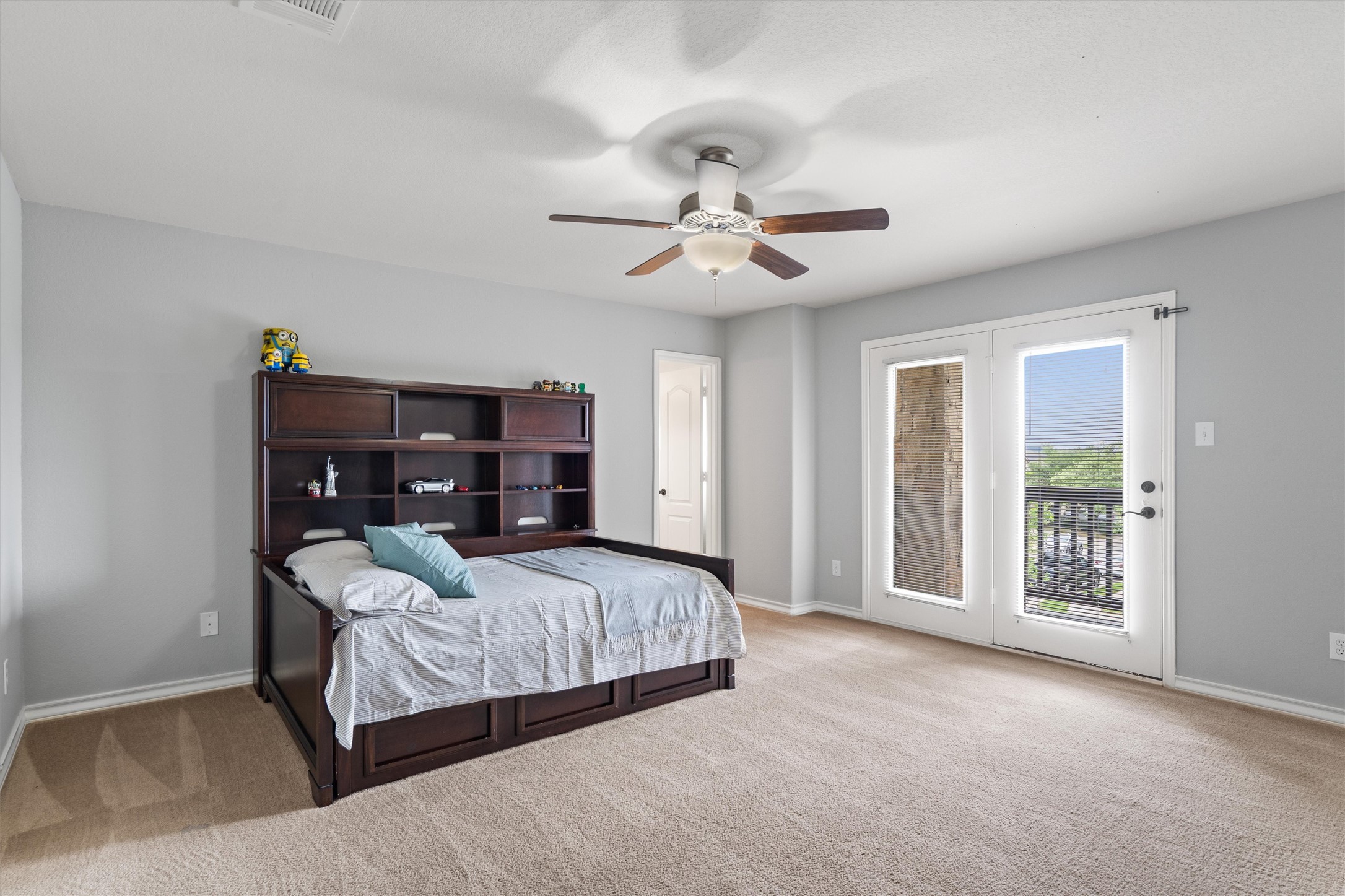 101 Breakaway Road Cedar Park, TX 78613 - Photo 29 of 37 Bedroom featuring access to outside, light carpet, and a ceiling fan