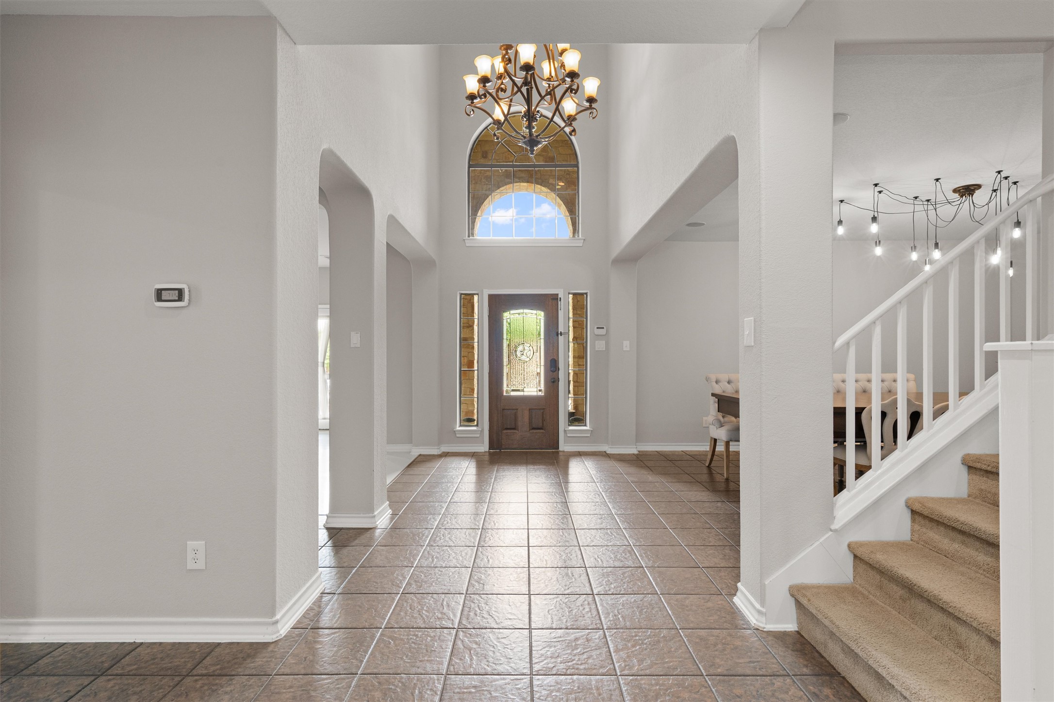 101 Breakaway Road Cedar Park, TX 78613 - Photo 3 of 37 Entrance foyer with hanging lights, a high ceiling, and arched walkways