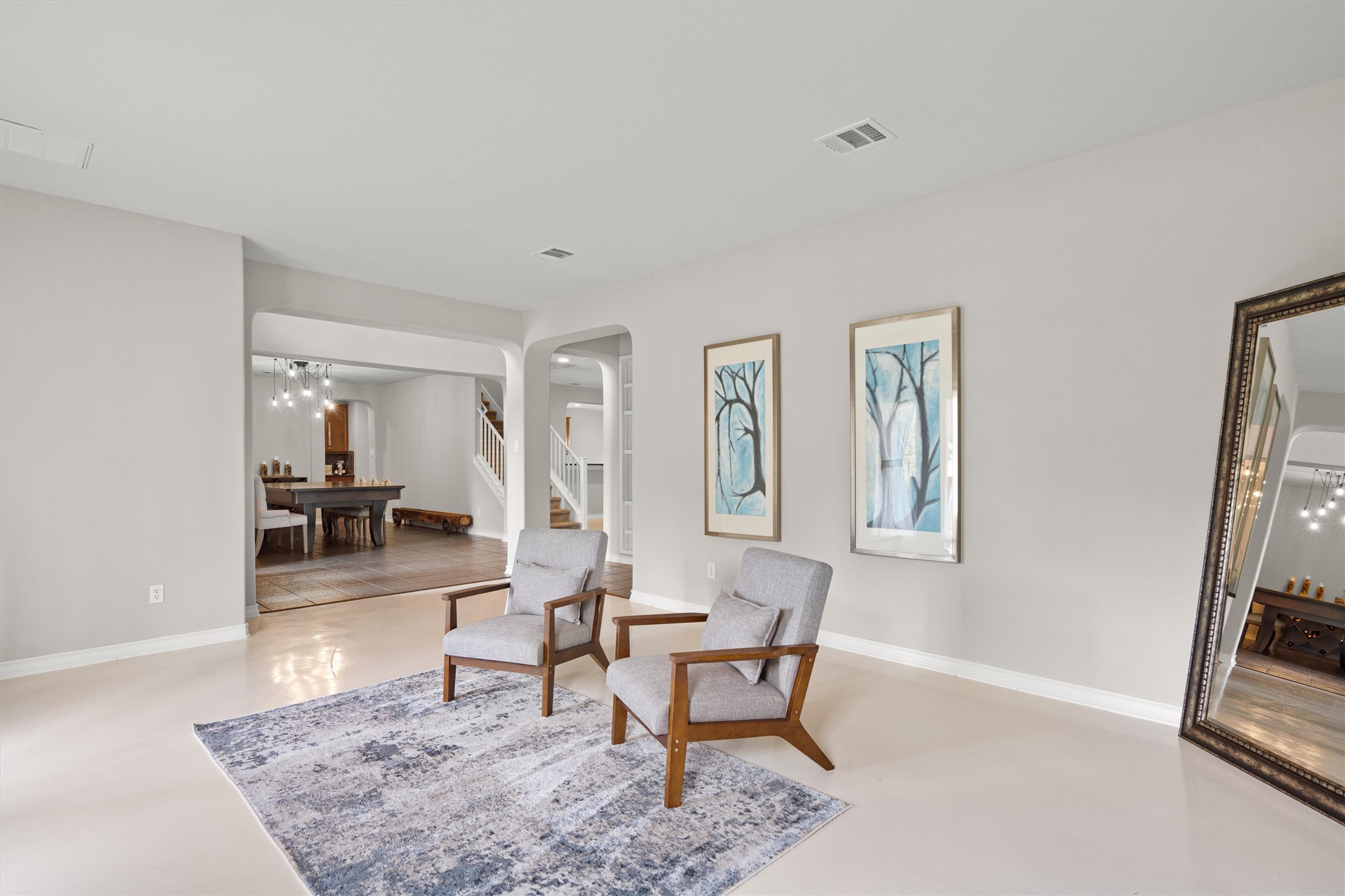 101 Breakaway Road Cedar Park, TX 78613 - Photo 5 of 37 Living area featuring arched walkways, hanging lights, and finished concrete flooring
