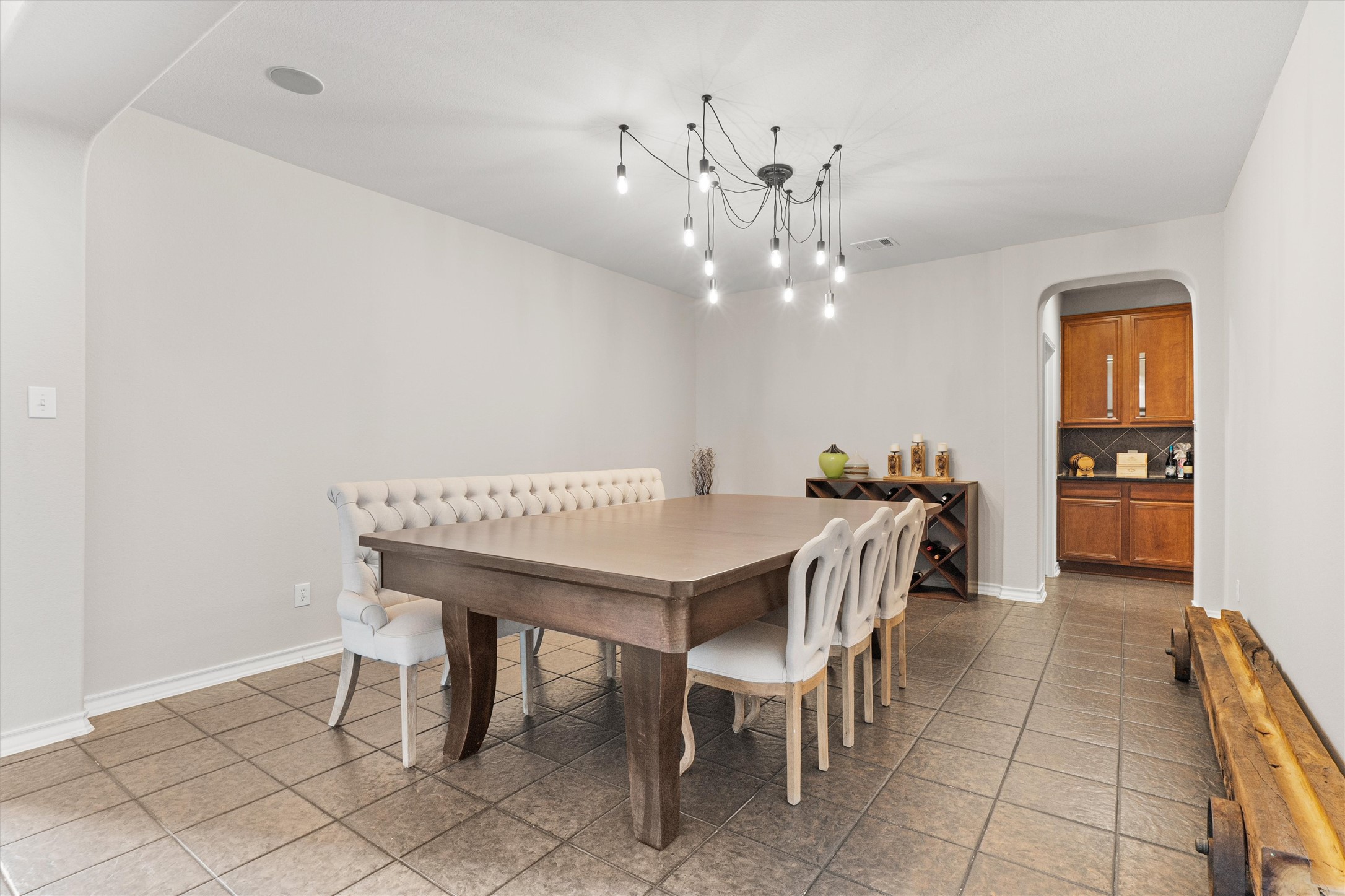 101 Breakaway Road Cedar Park, TX 78613 - Photo 7 of 37 Dining room with arched walkways, a chandelier, and light tile patterned floors