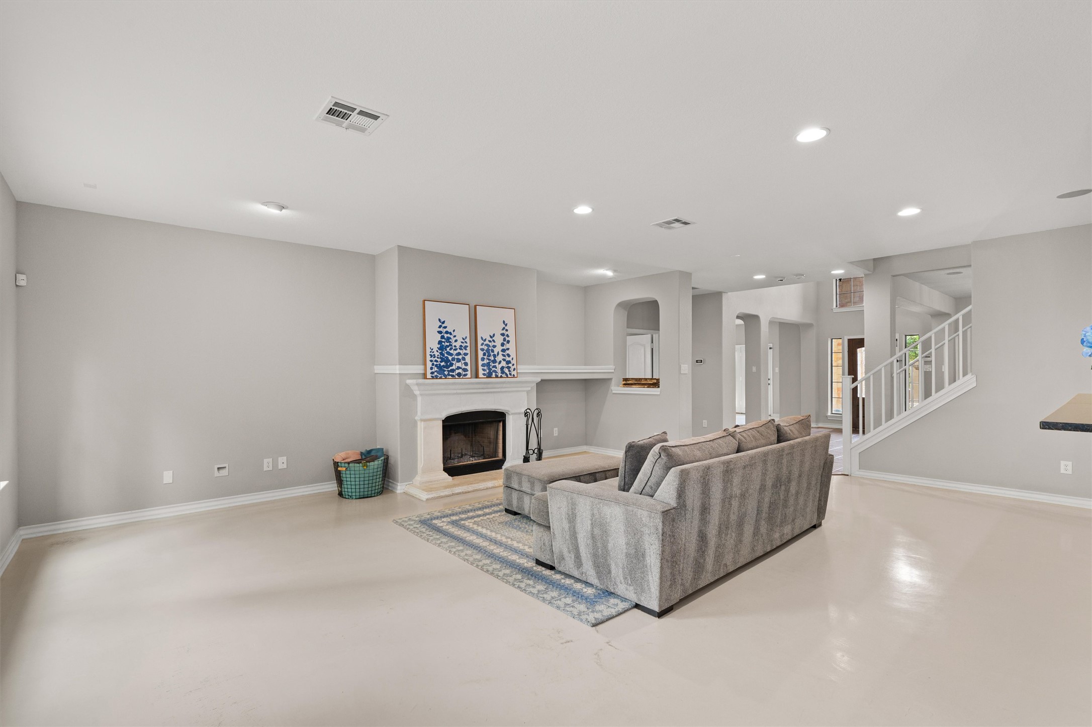 101 Breakaway Road Cedar Park, TX 78613 - Photo 10 of 37 Living area featuring finished concrete flooring, a fireplace with raised hearth, and recessed lighting