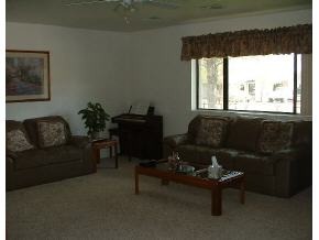 8079 East Barbara Road Prescott Valley, AZ 86314 - Photo 3 of 16 a living room with furniture and a large window
