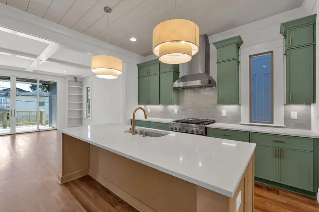 a kitchen with stainless steel appliances granite countertop a sink and a wooden cabinets