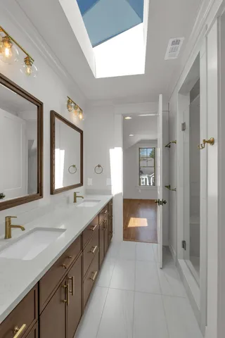 a bathroom with a double vanity sink and a mirror