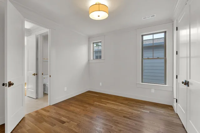 a view of a room with wooden floor and window