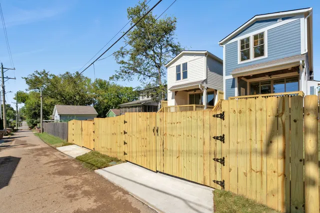 a view of a building with wooden fence