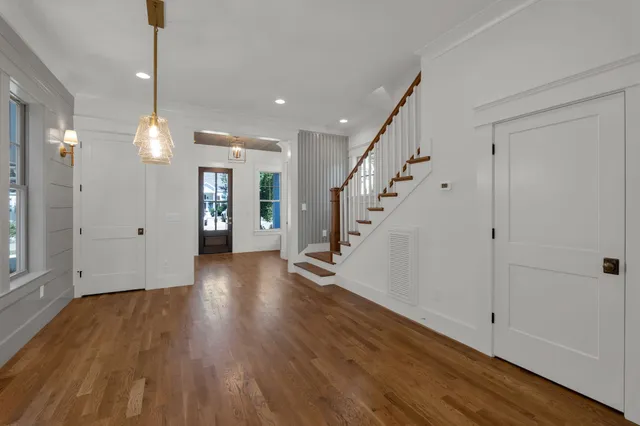 a view of a room with wooden floor and window