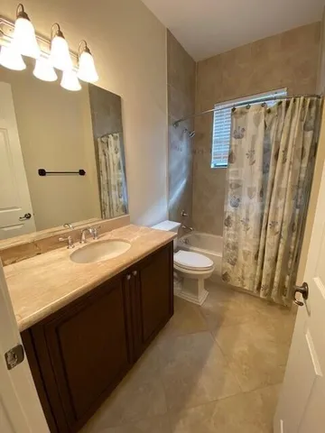 a bathroom with a sink toilet and mirror