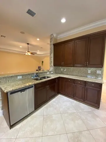 a kitchen with stainless steel appliances granite countertop a refrigerator stove and microwave