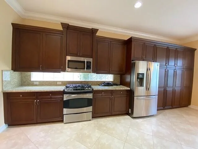 a view of a kitchen with a sink dishwasher and a refrigerator