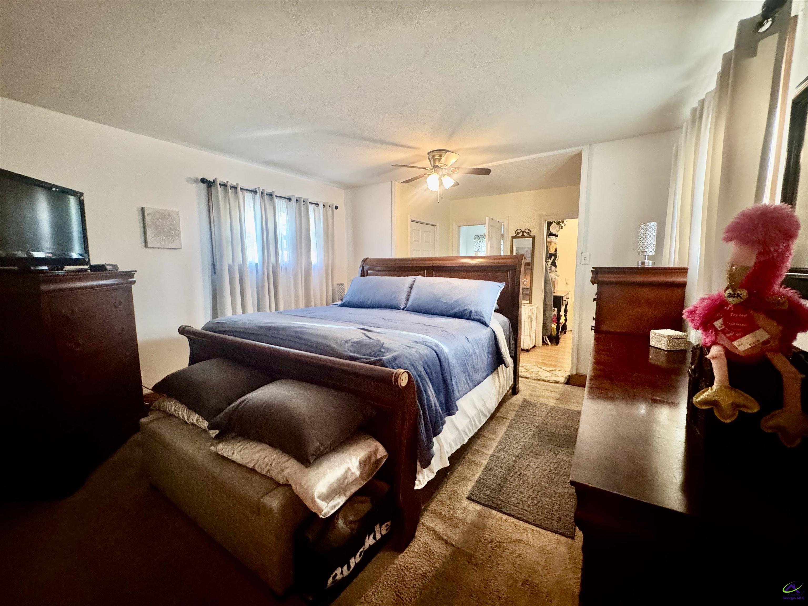 914 Adderton Street Americus, GA 31719 - Photo 27 of 53 a bedroom with a bed and wooden floor