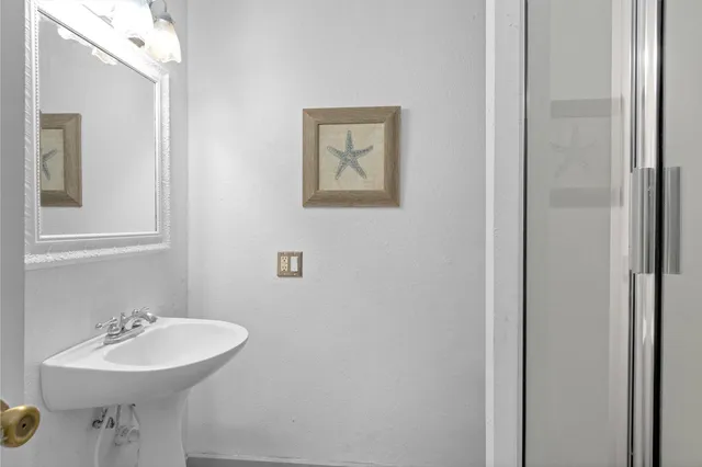 a bathroom with a sink and mirror