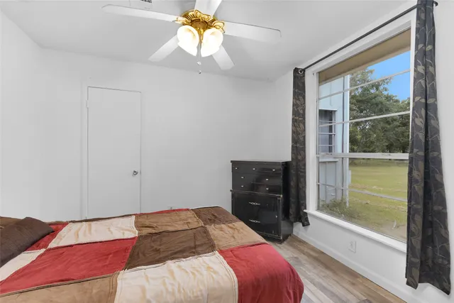 a bedroom with a bed and a window