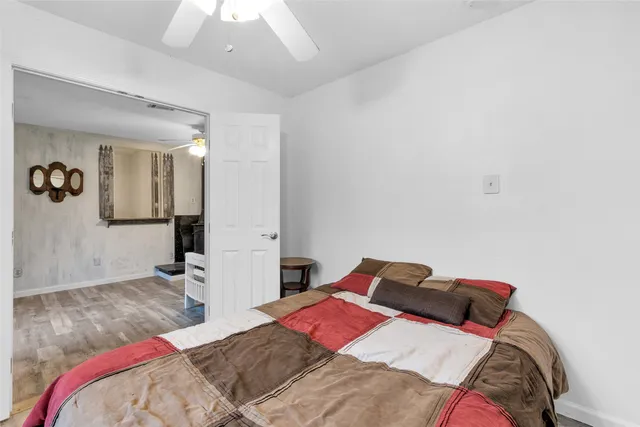 a bedroom with a bed and painting on the wall