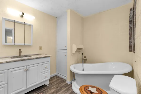 a spacious bathroom with a granite countertop sink and a mirror