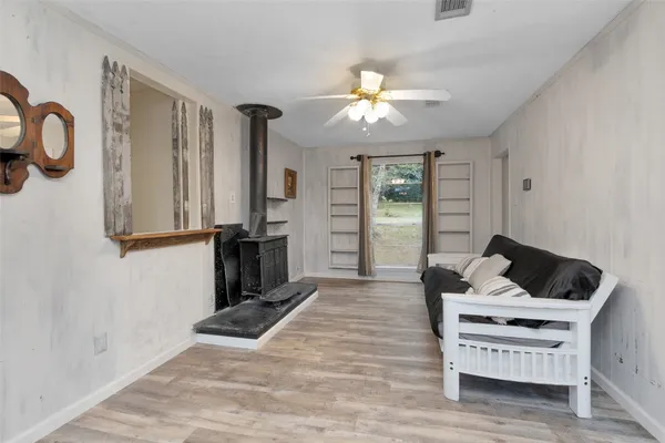 a living room with furniture a fireplace and flat screen tv