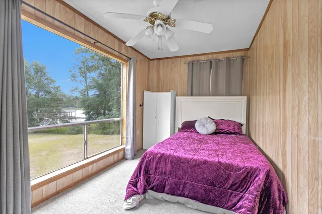 a bed sitting in a bedroom next to a window