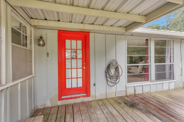 a area with wooden floor and windows