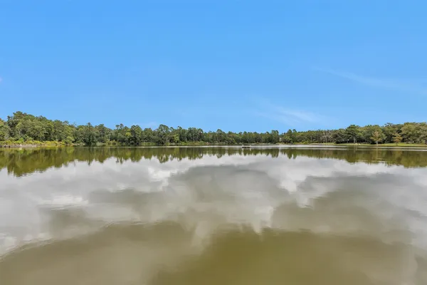 a view of a lake with houses in the back