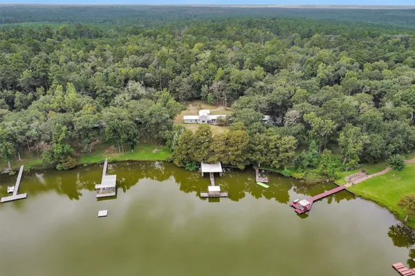 an aerial view of a house with a yard swimming pool and outdoor seating