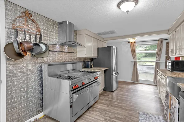 a kitchen with stainless steel appliances granite countertop a stove and a refrigerator