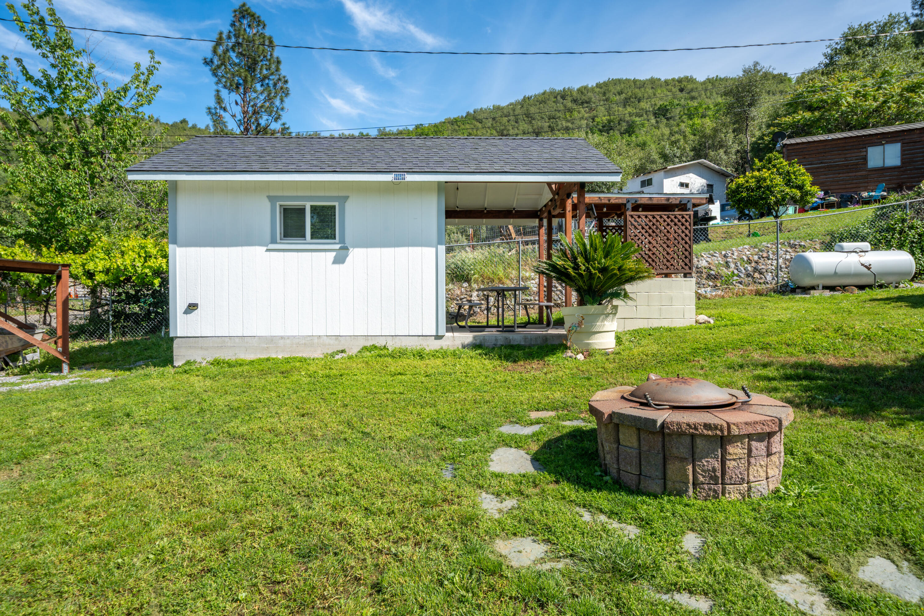 22151 Ravine Court Redding, CA 96003 - Photo 22 of 34 a view of a house with backyard and sitting area