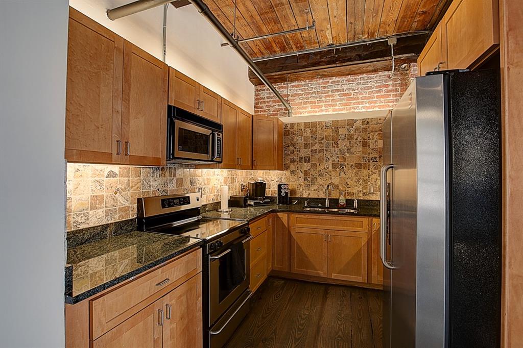 342 Marietta Street Northwest, Unit 1 Atlanta, GA 30313 - Photo 4 of 9 a kitchen with stainless steel appliances granite countertop a stove a sink and a refrigerator